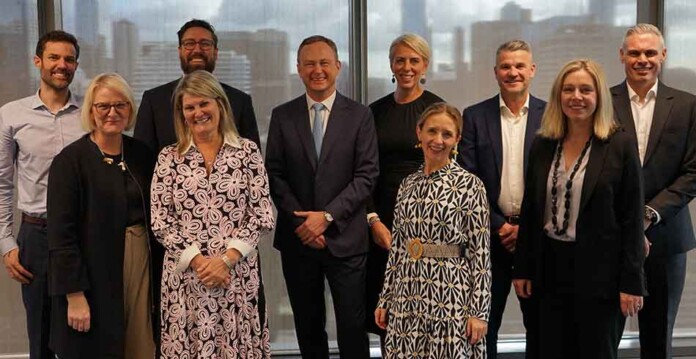 Male and female AusNet executives smiling for photograph