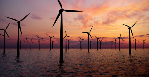 Beautiful peach and purple sky with offshore wind turbines (port)