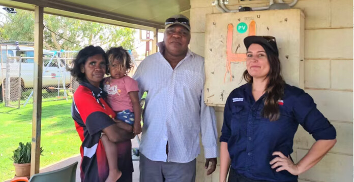 Warumungu Elder Frank Jupurrurla (centre), with family members Serena and Nina-Simone (left) and Lauren Mellor (Original Power) (First Nations solar)