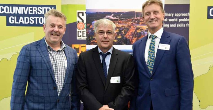 Professor Jonathan Love with Stanwell executives in front of CQUniversity signage