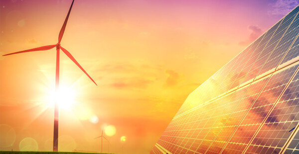 Wind turbine with solar panels against beautiful sunny orange sky (renewables tender)