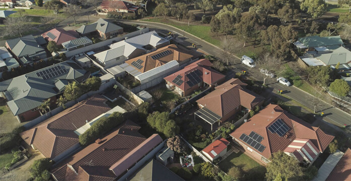 Aerial photo of community housing with rooftop solar panels