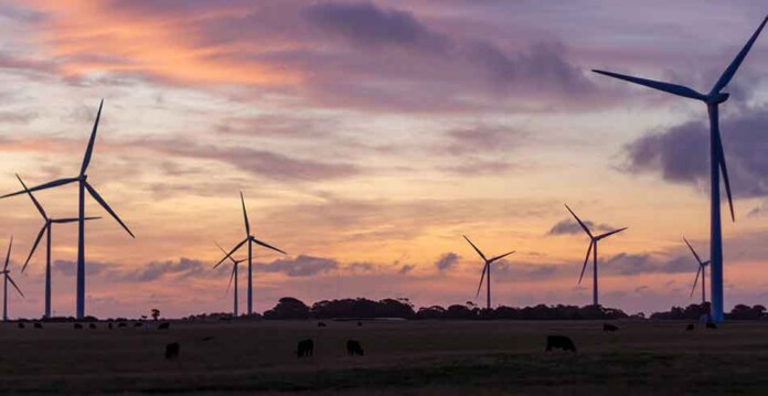 Wind turbines with beautiful purple and orange sky at sunset